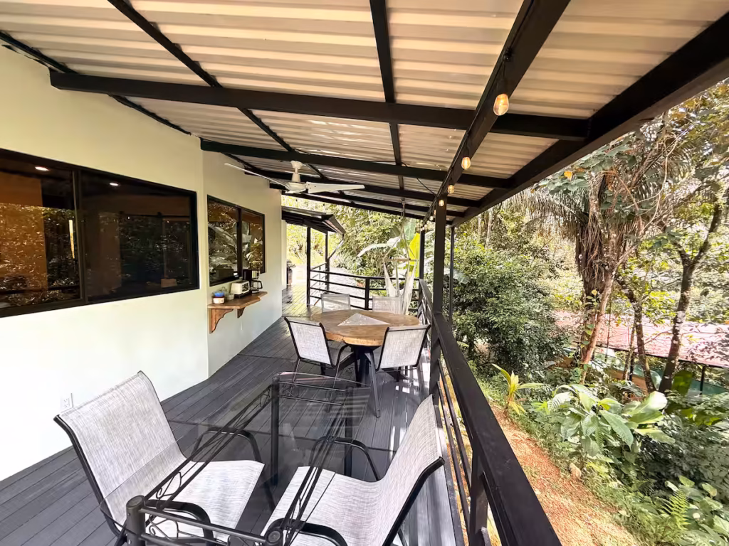 Terrasse couverte de la villa de 4 chambres avec espace repas extérieur et vue sur la jungle.