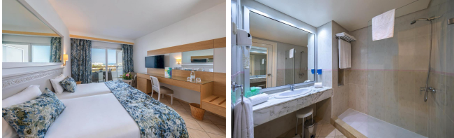 Chambre vue mer avec balcon et salle de bain moderne.